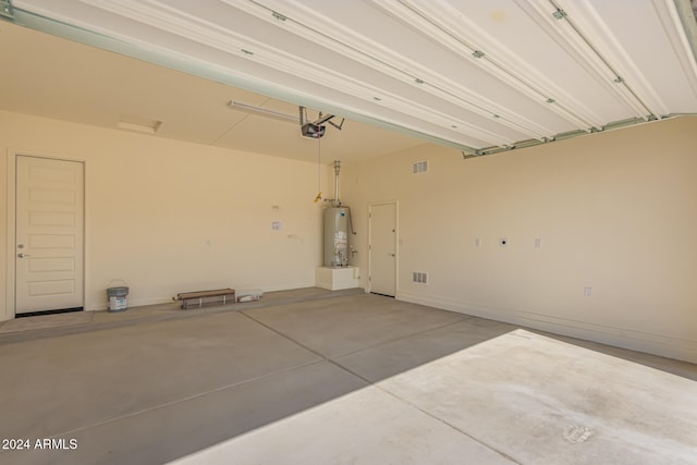 garage featuring a garage door opener and gas water heater