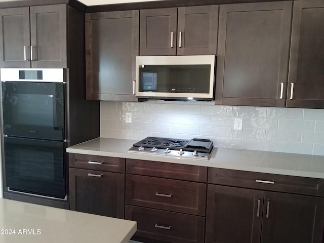 kitchen with backsplash, appliances with stainless steel finishes, and dark brown cabinets