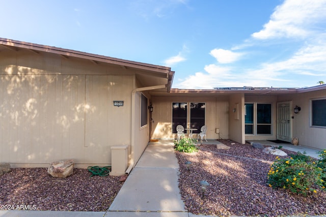 property entrance featuring a patio