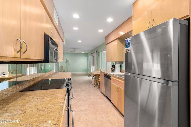 kitchen with ceiling fan, light tile patterned floors, and appliances with stainless steel finishes