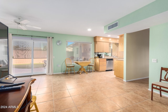 kitchen featuring light brown cabinetry, light tile patterned floors, stainless steel dishwasher, and ceiling fan