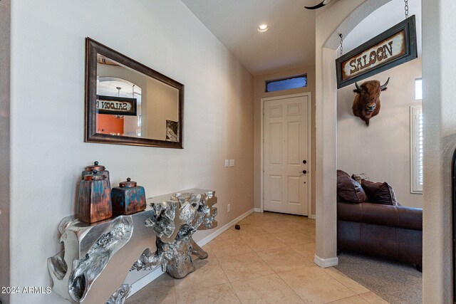 entrance foyer featuring baseboards, recessed lighting, and tile patterned floors