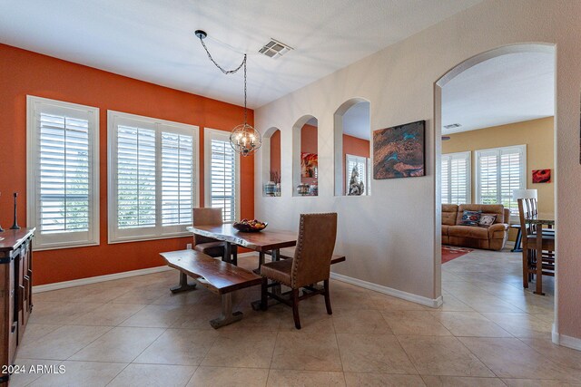dining area with baseboards, a healthy amount of sunlight, and visible vents