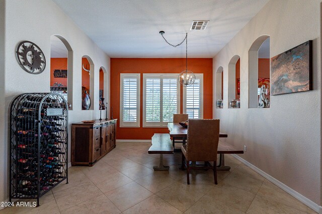 dining area featuring light tile patterned floors, baseboards, and visible vents