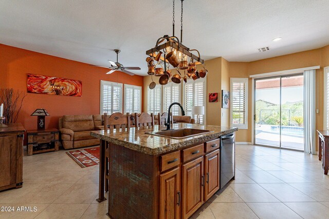 kitchen featuring stainless steel dishwasher, a sink, visible vents, and a wealth of natural light