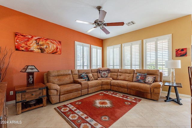 living area with baseboards, visible vents, a ceiling fan, and light tile patterned flooring