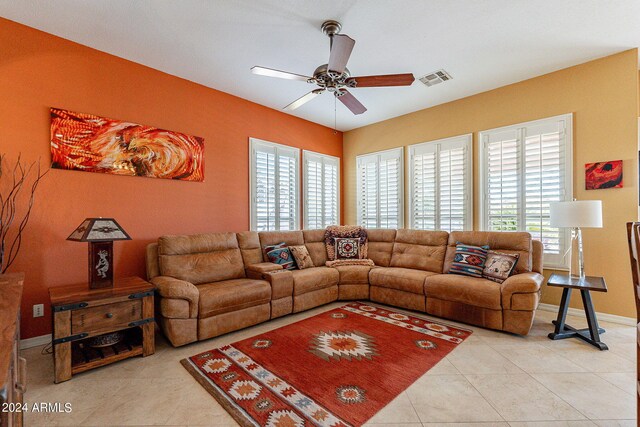 living area with a ceiling fan, baseboards, visible vents, and light tile patterned flooring