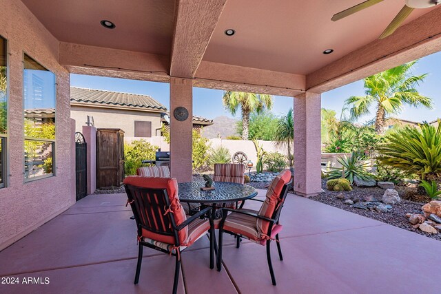 view of patio featuring fence and outdoor dining space