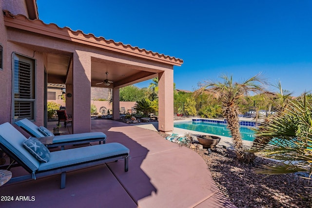 view of patio / terrace with a ceiling fan, a fenced in pool, and a fenced backyard