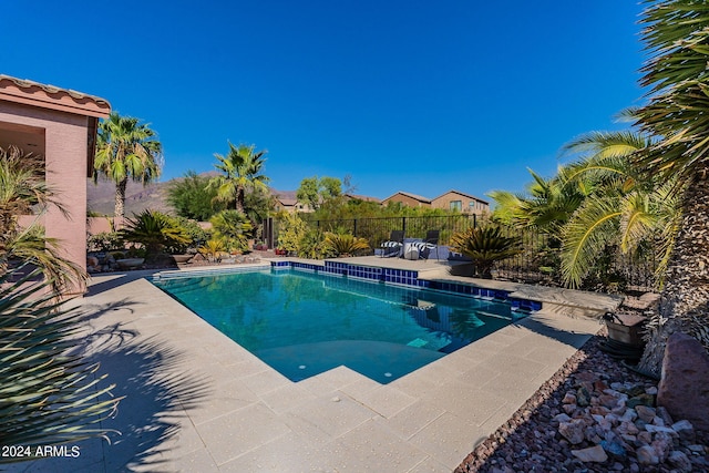 view of pool with fence, a fenced in pool, and a patio