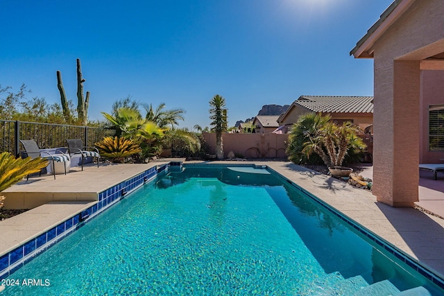 view of swimming pool with a fenced in pool, a fenced backyard, and a patio