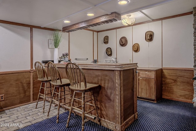 bar with wooden walls and ornamental molding