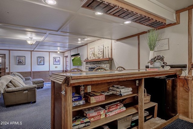 interior space featuring a stone fireplace and carpet flooring