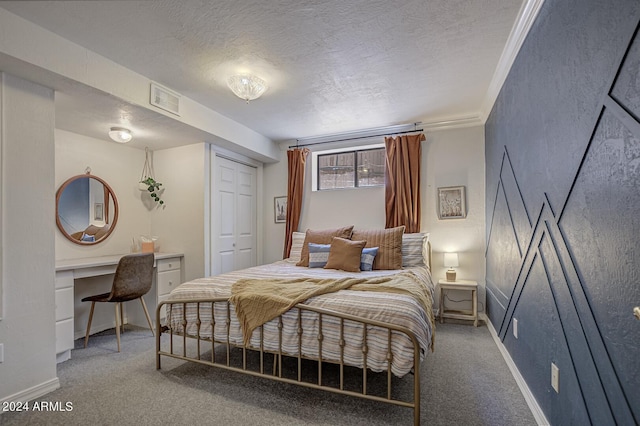 bedroom with carpet flooring, a closet, a textured ceiling, and crown molding