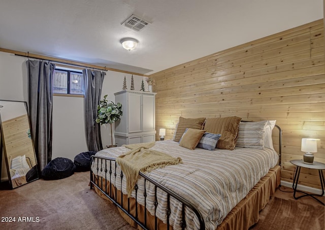 bedroom featuring wood walls and carpet flooring