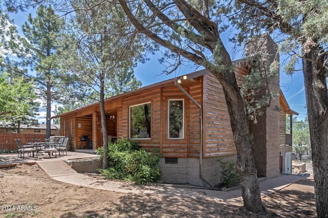 rear view of property featuring a patio area