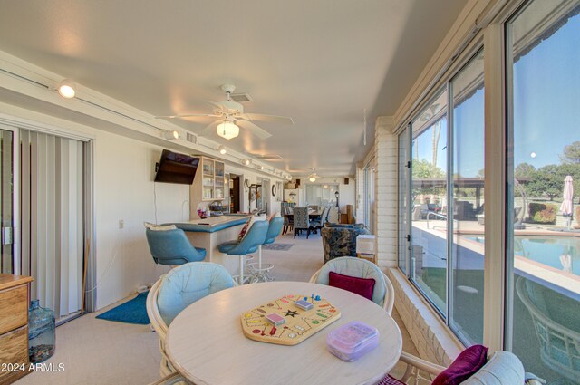 sunroom / solarium featuring ceiling fan