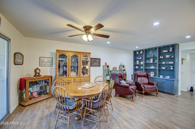 dining space with ceiling fan and light wood-type flooring