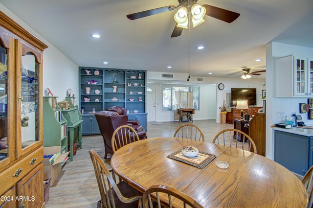 dining room with light hardwood / wood-style floors and ceiling fan