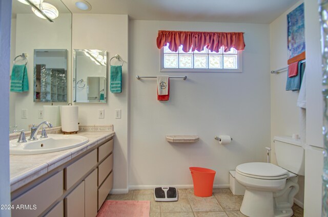 bathroom with vanity, toilet, and tile patterned floors