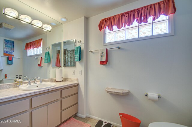 bathroom with tile patterned flooring and vanity