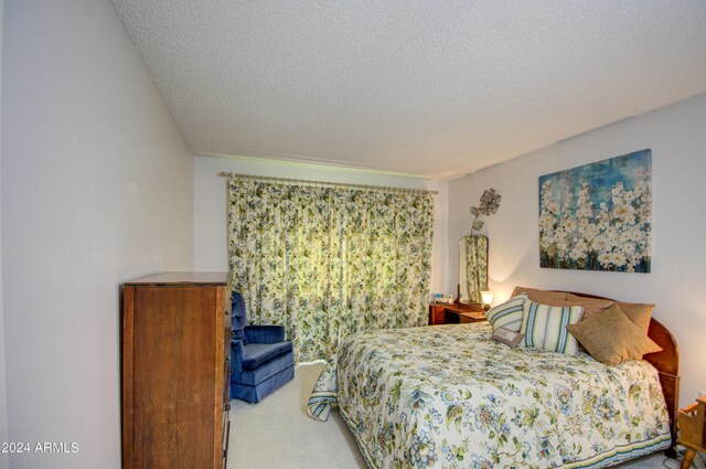 bedroom featuring a textured ceiling and carpet floors