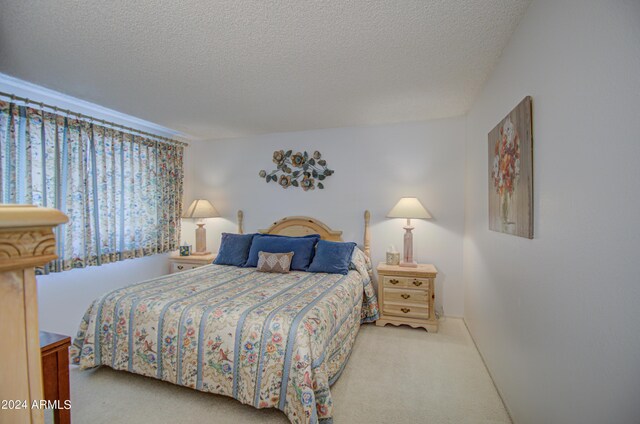 carpeted bedroom featuring a textured ceiling