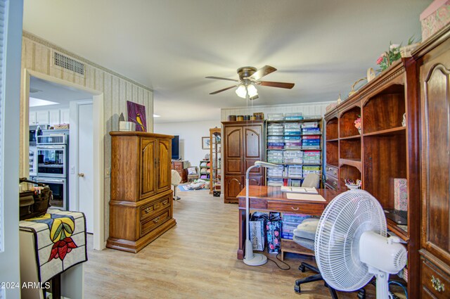 home office featuring ceiling fan and light hardwood / wood-style flooring