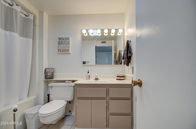 full bathroom with vanity, toilet, shower / bathtub combination with curtain, and tile patterned floors