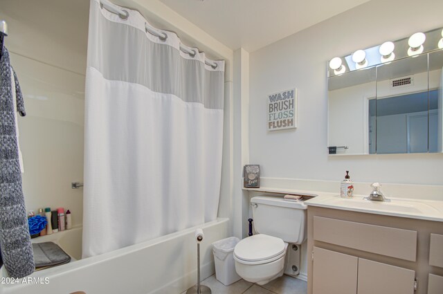 full bathroom featuring shower / bathtub combination with curtain, tile patterned flooring, vanity, and toilet