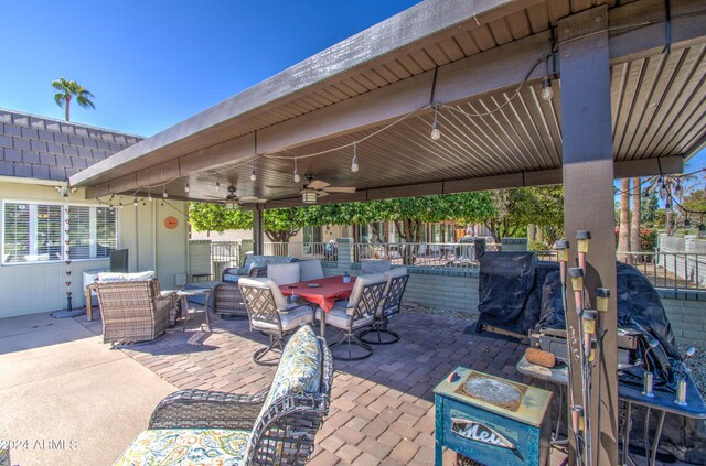 deck featuring outdoor lounge area, a patio area, and ceiling fan