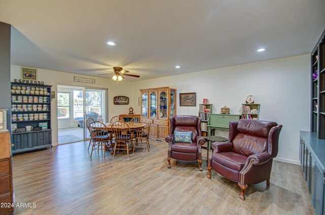 sitting room with light hardwood / wood-style floors and ceiling fan