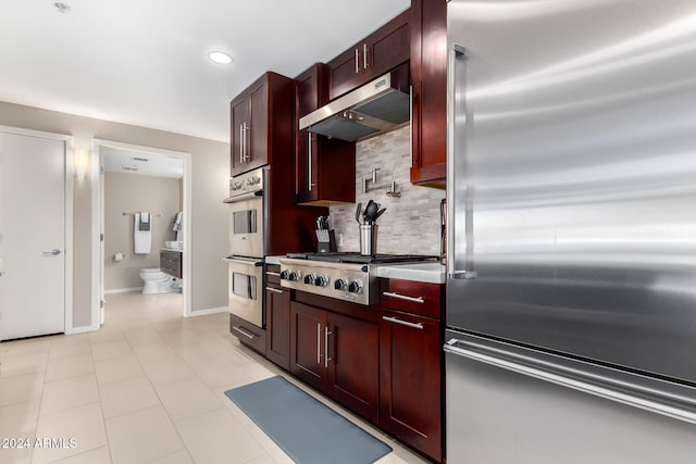 kitchen with tasteful backsplash and appliances with stainless steel finishes