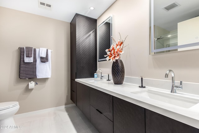 bathroom with tile patterned floors, vanity, and toilet