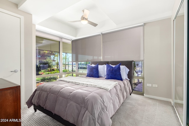 bedroom featuring light colored carpet and ceiling fan