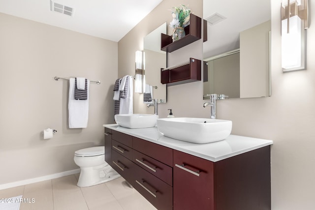 bathroom featuring tile patterned flooring, vanity, and toilet