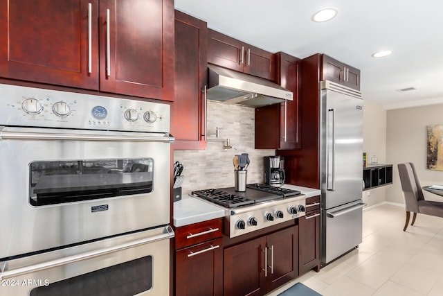 kitchen featuring appliances with stainless steel finishes, backsplash, extractor fan, and light tile patterned flooring