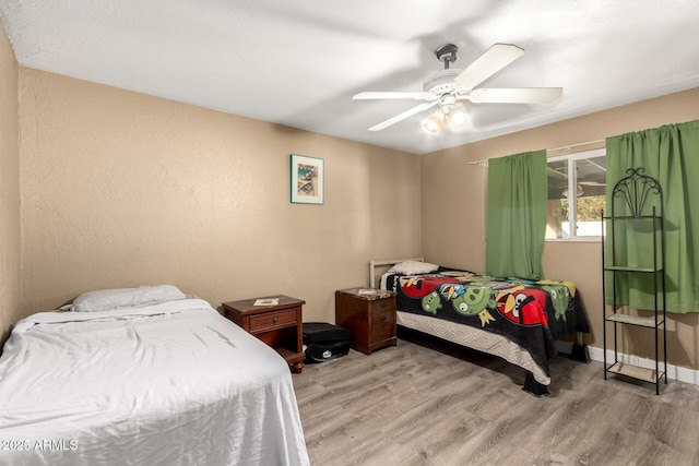 bedroom featuring ceiling fan and light wood-type flooring