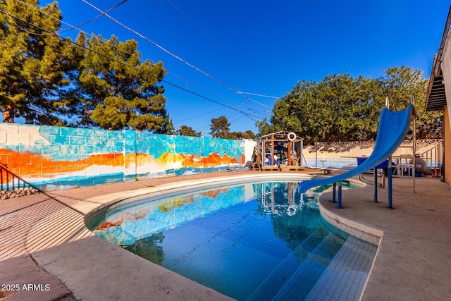 view of pool with a water slide