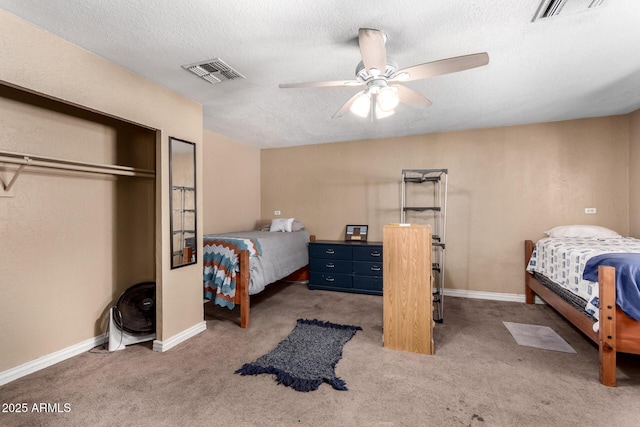 bedroom with ceiling fan, carpet floors, a closet, and a textured ceiling