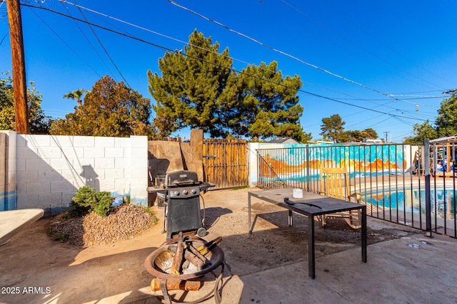 view of patio featuring grilling area and a fenced in pool