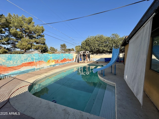 view of pool with a water slide