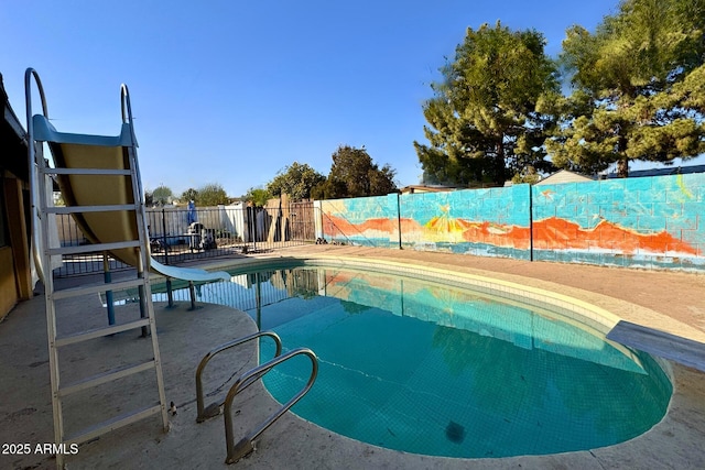 view of pool featuring a water slide and a patio