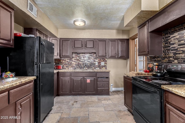 kitchen featuring dark brown cabinetry, sink, decorative backsplash, and black appliances