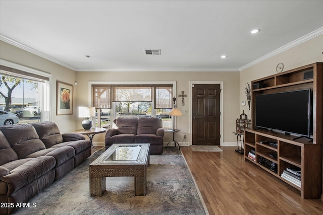 living room featuring hardwood / wood-style floors and crown molding