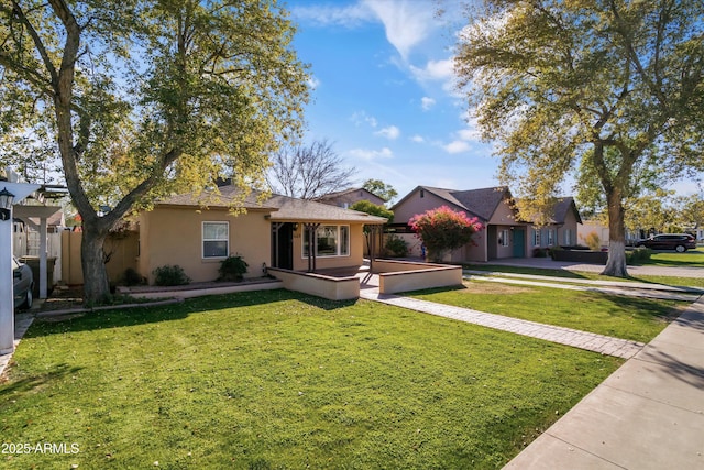 ranch-style home featuring a front yard