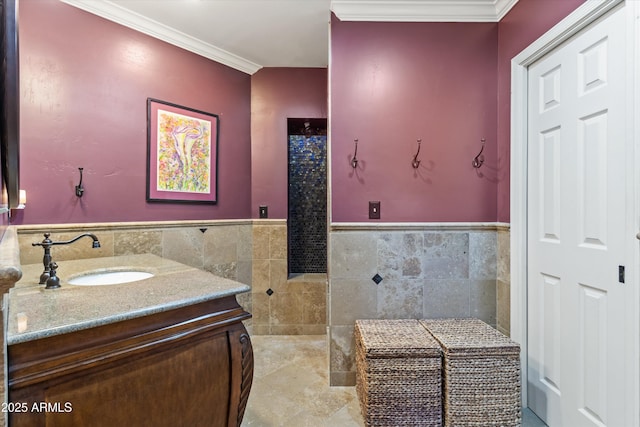 bathroom with vanity, crown molding, and tile walls