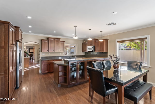 dining room featuring crown molding and hardwood / wood-style floors