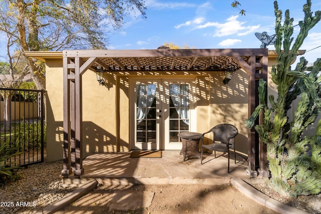 back of property with a patio, a pergola, and french doors