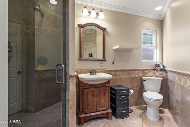 bathroom with tile walls, vanity, walk in shower, toilet, and crown molding